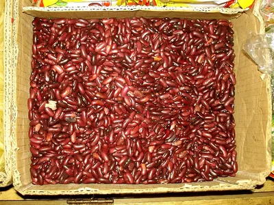 Red kidney beans for sale in a wooden tray