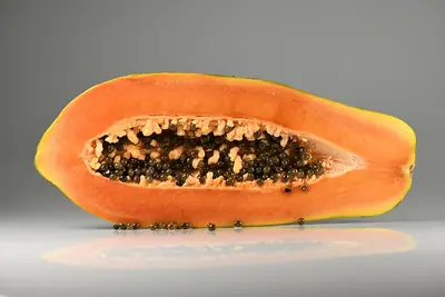 A pawpaw cut lengthways, showing its seeds